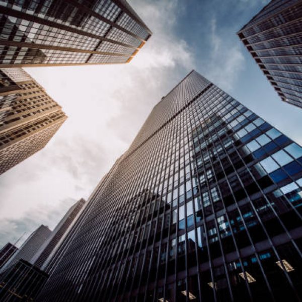 highrise buildings at Wall Street financial district in New York City from below.